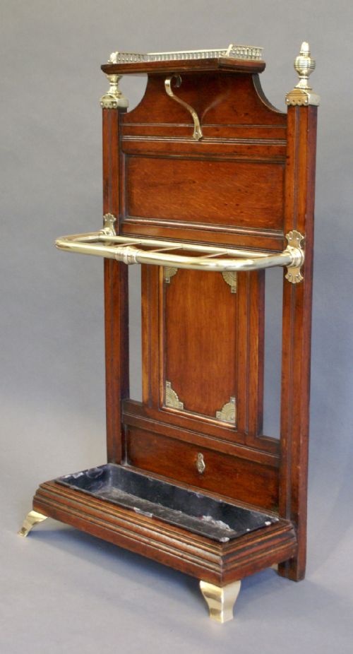 An Oak & Brass Stick Stand by James Shoolbred.