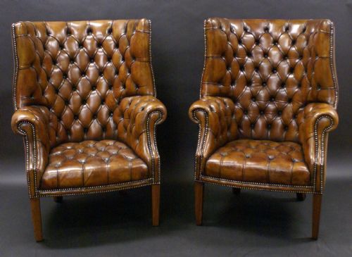 A Superb Pair of Barrel Back Leather Wing Chairs
