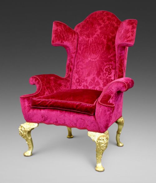 An Extravagant Carved Giltwood Wing Chair