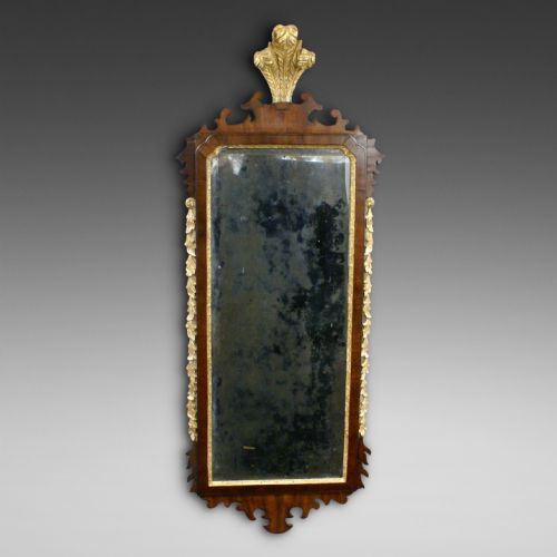 AN 18TH CENTURY MAHOGANY PARCEL GILT MIRROR