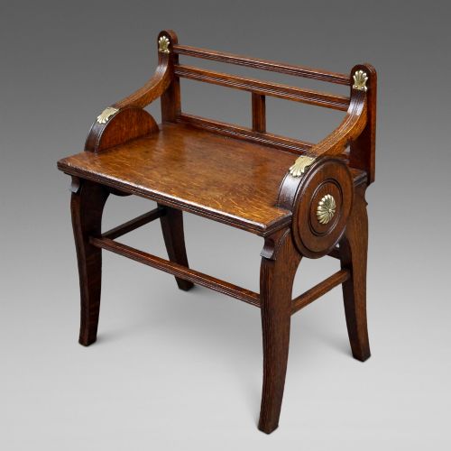 AN OAK AND BRASS MOUNTED HALL BENCH BY JAMES SHOOLBRED CO