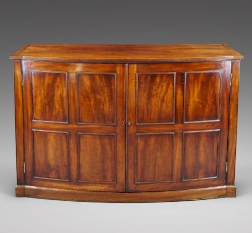 AN UNUSUAL GEORGE III BOWFRONTED CUPBOARD