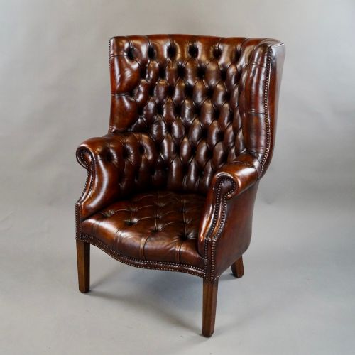 A DEEP BUTTONED CHESTNUT BROWN BARREL BACK WING CHAIR - ADDITIONAL PHOTO 1