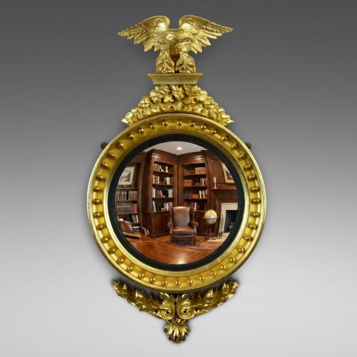 A REGENCY GILT WOOD CONVEX MIRROR
