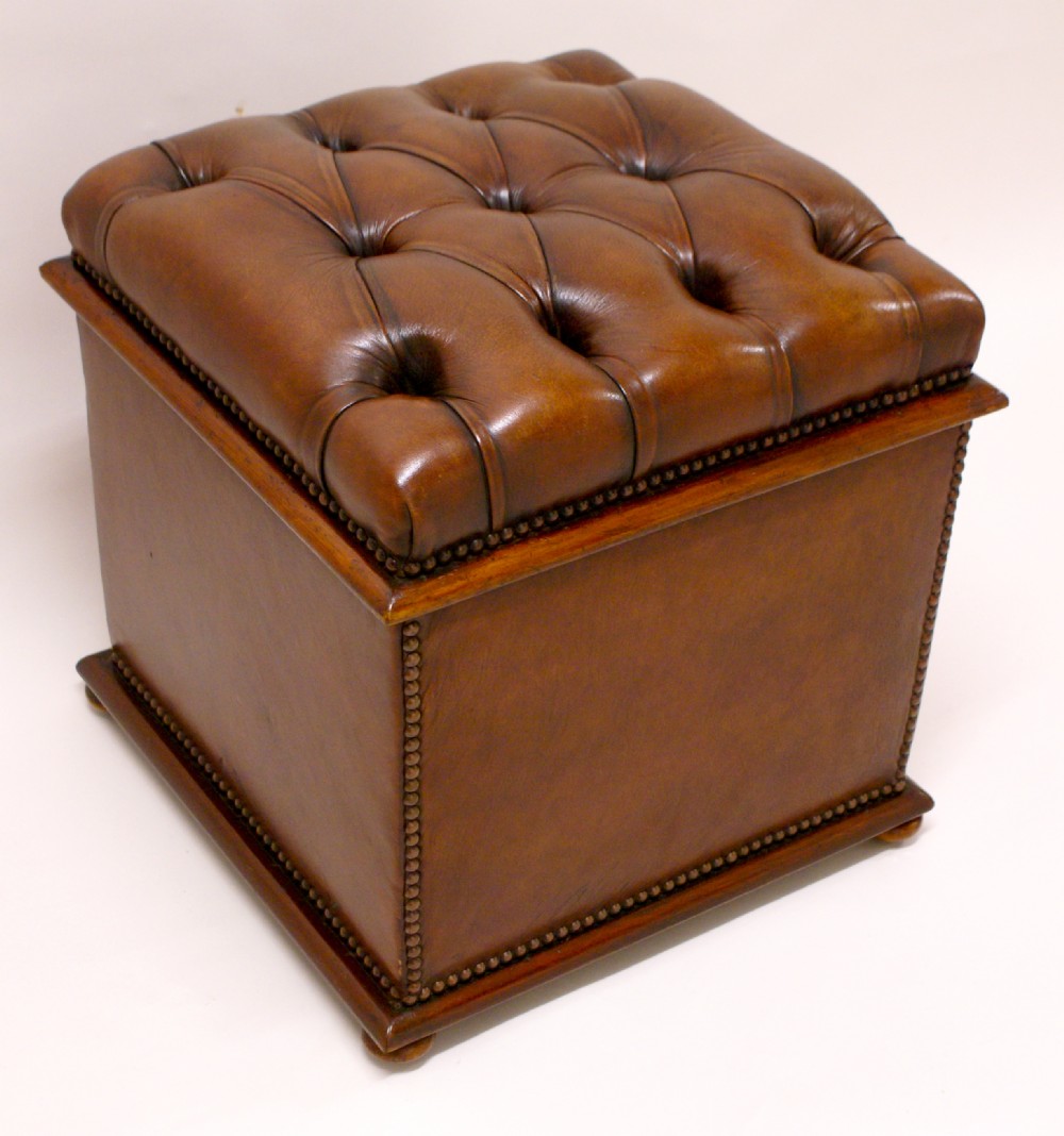 A Victorian mahogany and leather covered ottoman