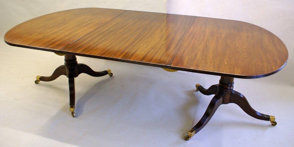 A George III mahogany twin pedestal dining table