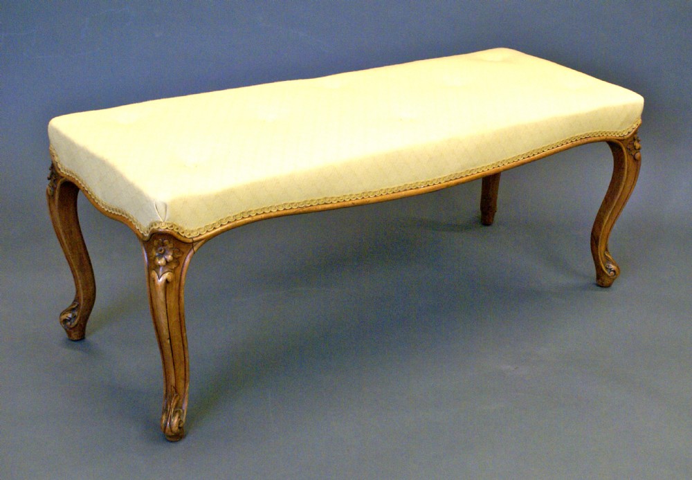 A mid Victorian walnut long stool