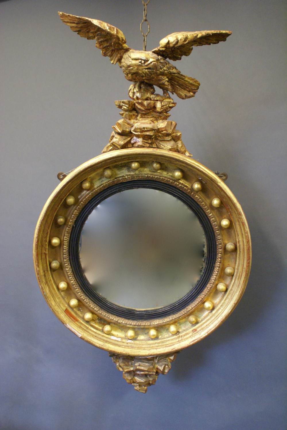 A Regency convex mirror, with carved eagle.