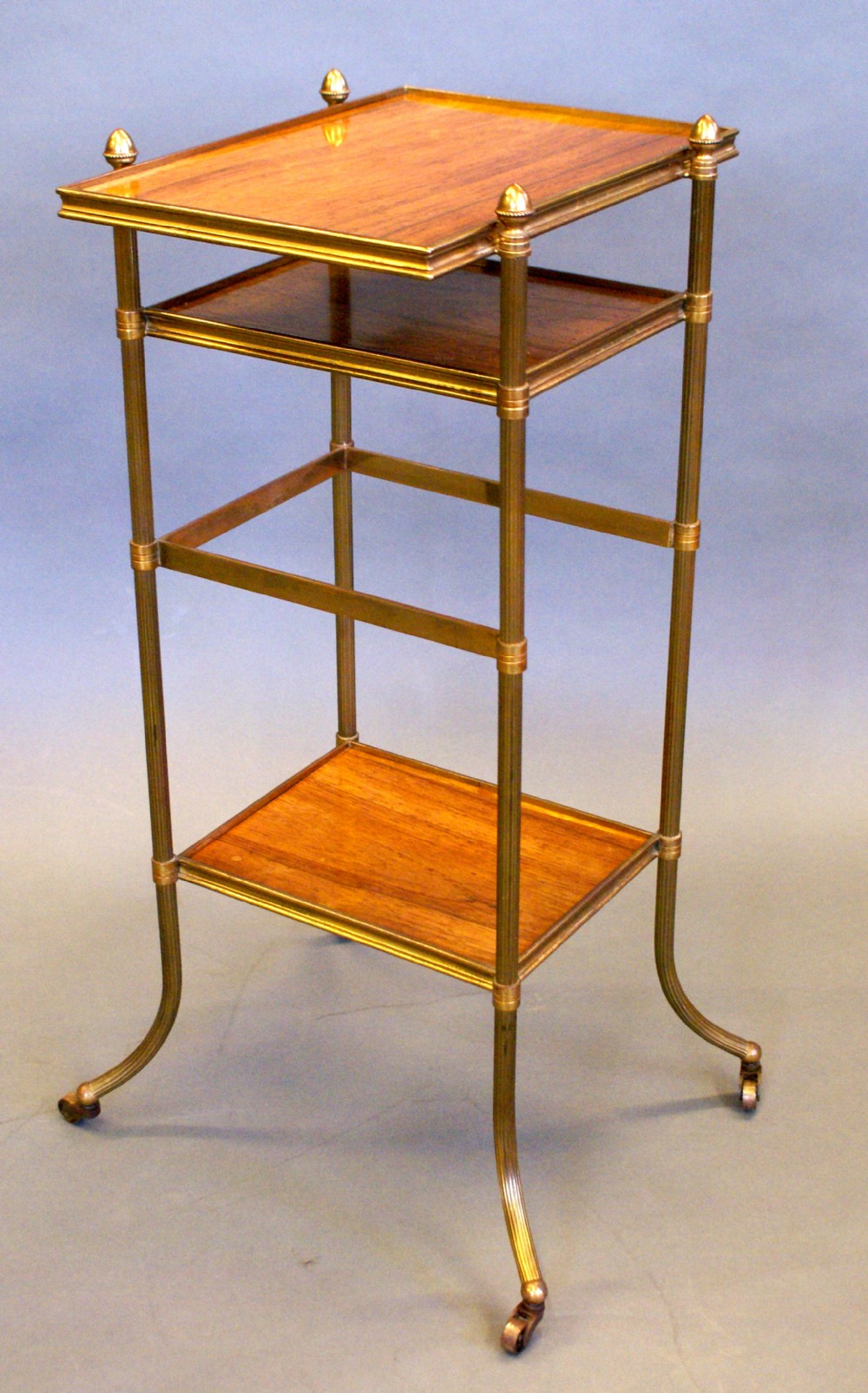 A rosewood and brass etagere.