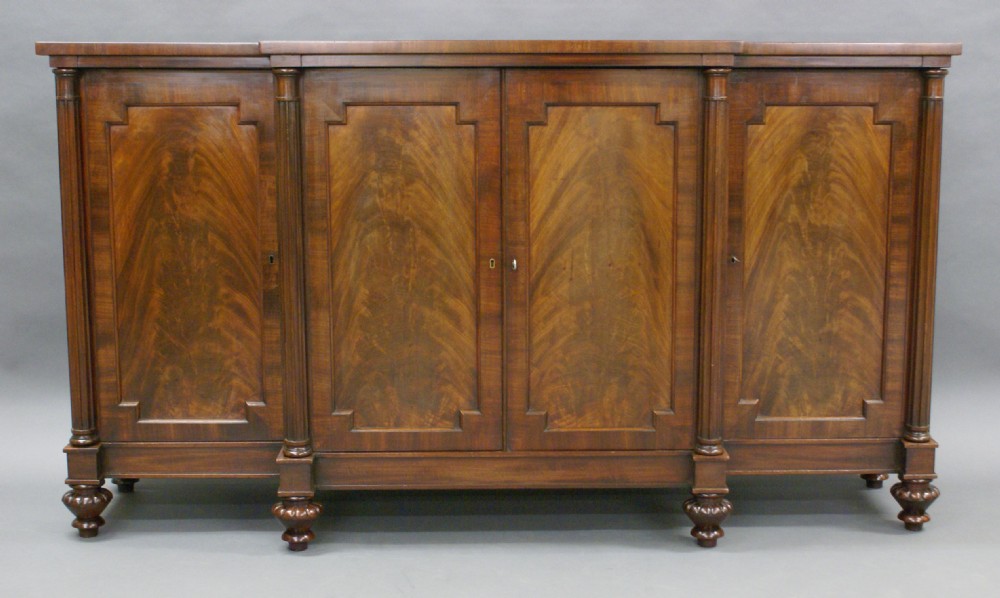 A Regency period mahogany breakfront cabinet.