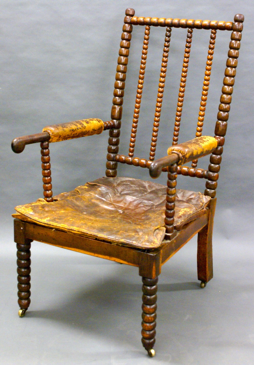 A late 17th century bobbin turned, laburnum-wood arm chair.