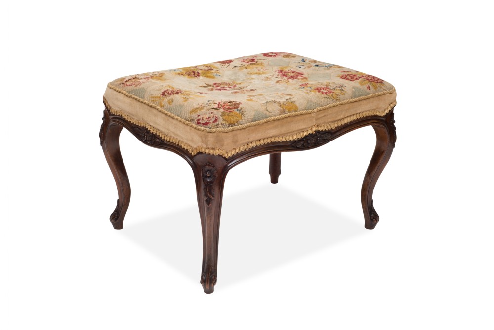 A carved Victorian walnut stool