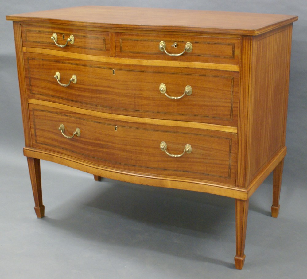 A late 19th century French satinwood commode.