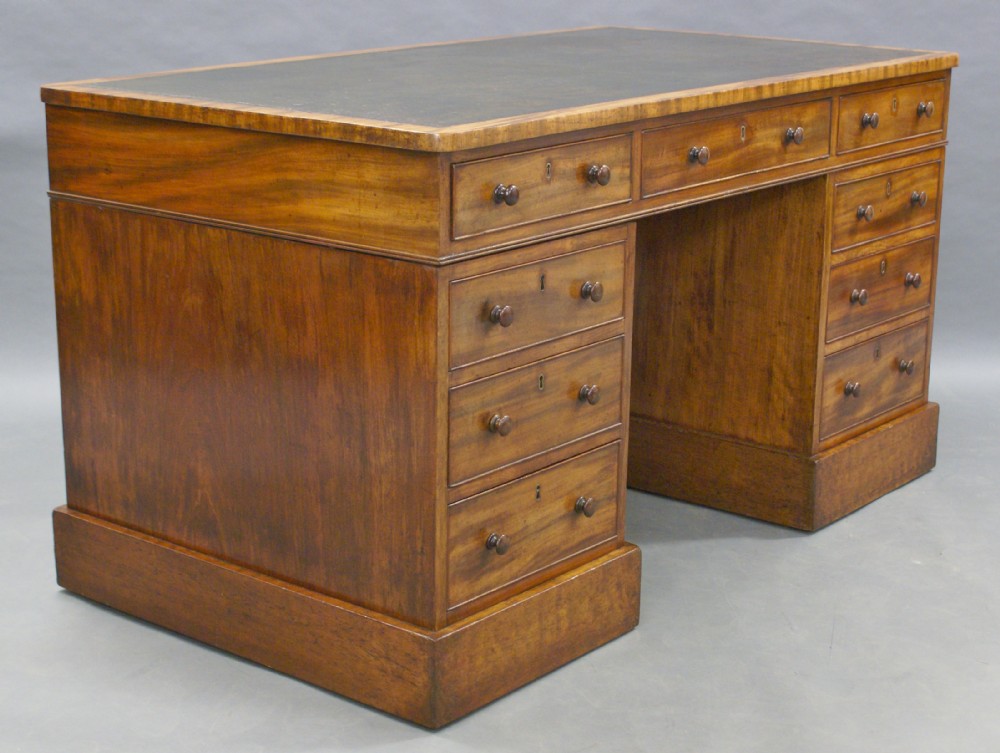 A very unusual George III mahogany pedestal desk
