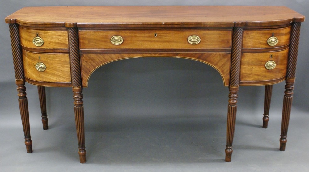 A George III mahogany 6 leg sideboard