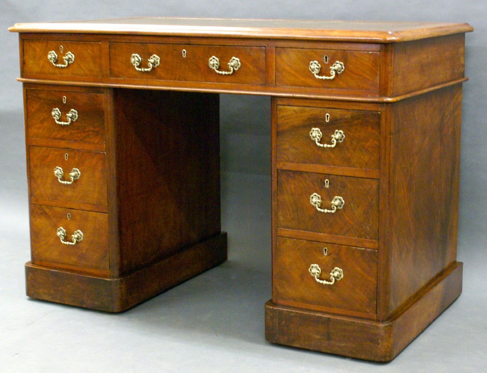 A small Victorian figured walnut pedestal desk