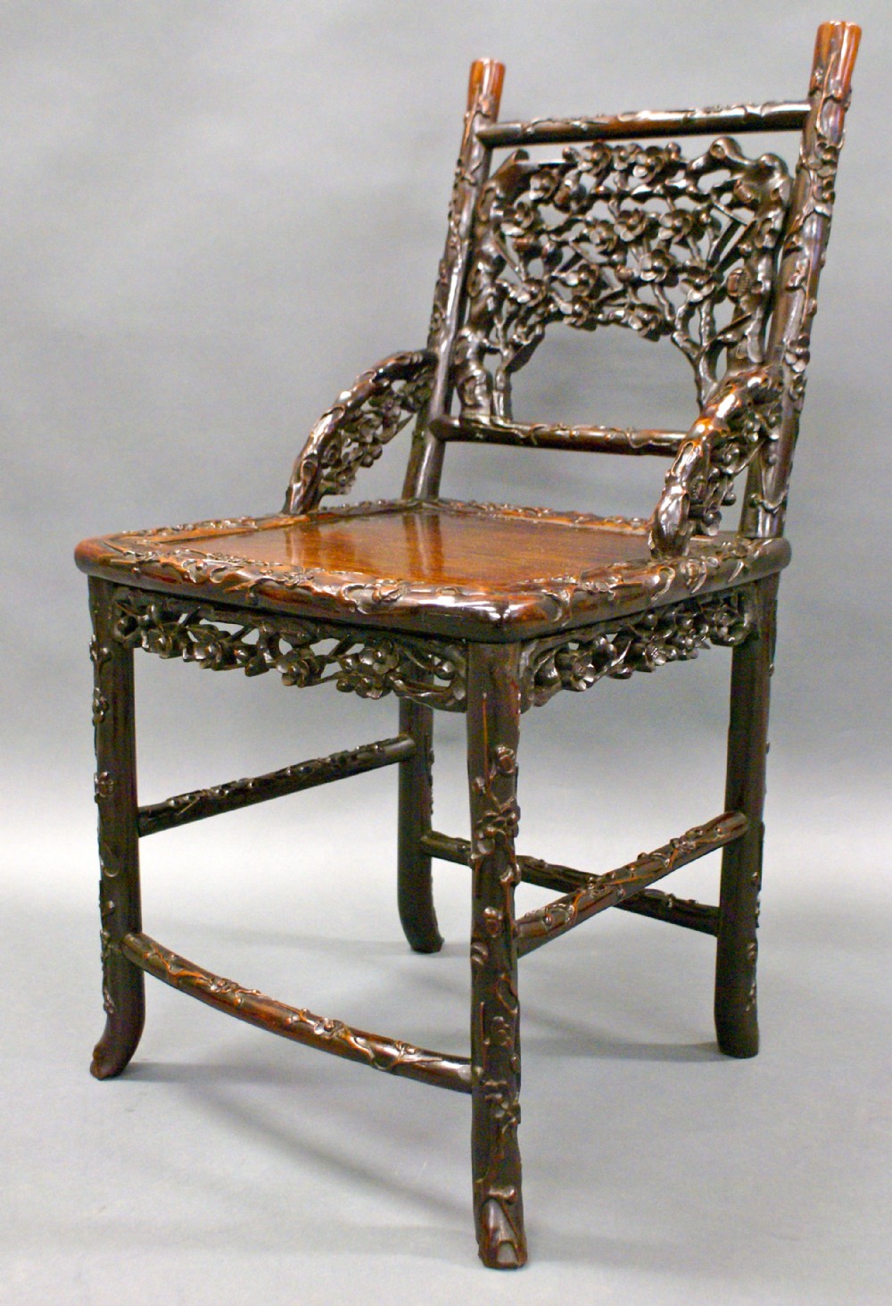 A beautifully carved Chinese hardwood arm chair
