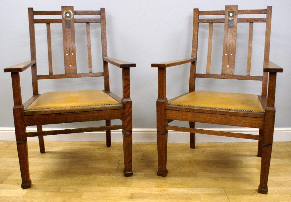 An impressive pair of Arts & Crafts Oak arm chairs
