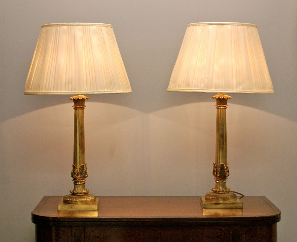 A fine pair of French, brass and gilt lacquered table lamps