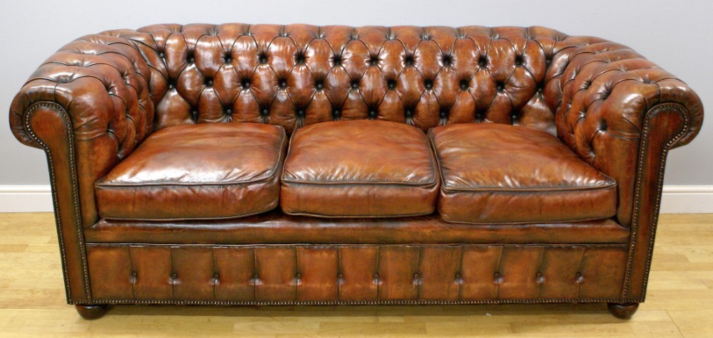 A buttoned and brass nailed, leather chesterfield