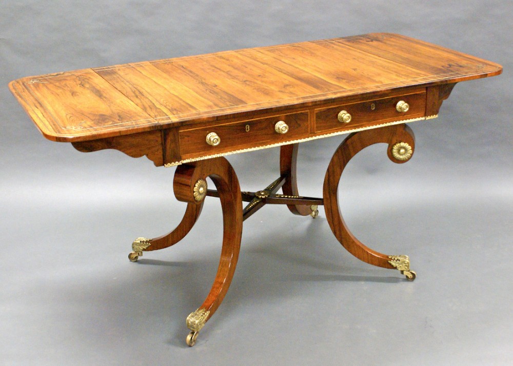A fine Regency rosewood and brass inlaid sofa table