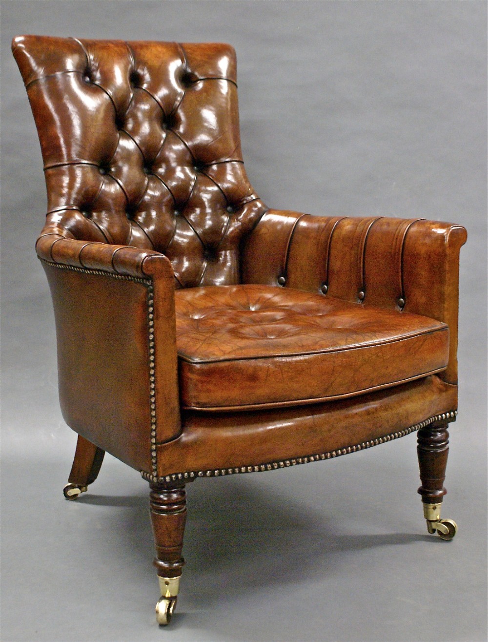 A William IV rosewood, leather upholstered arm chair.