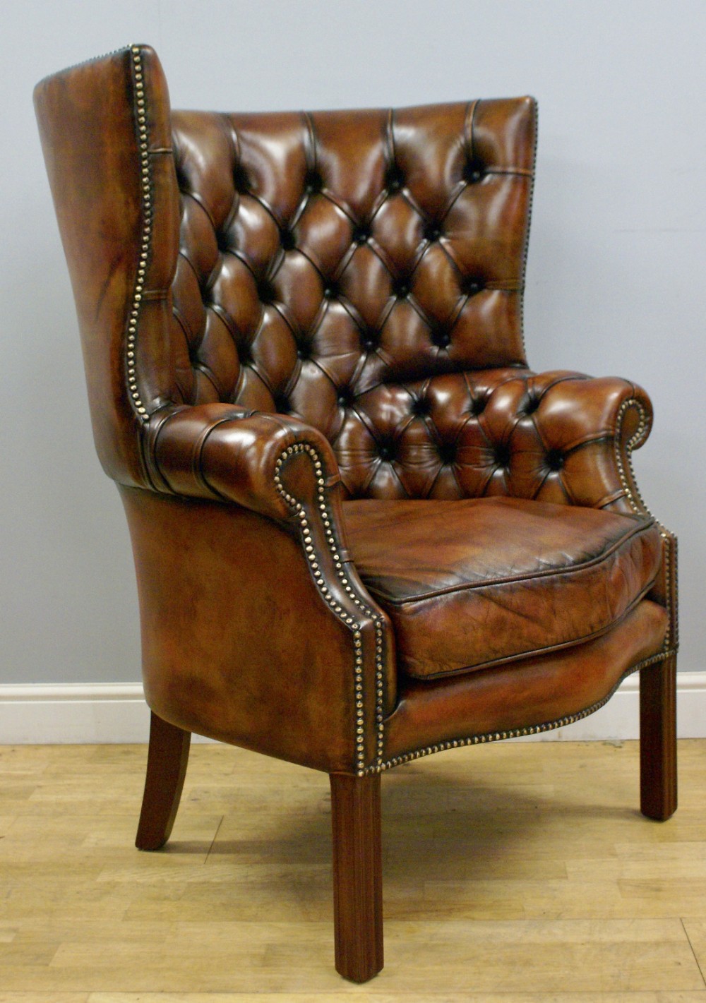 A Georgian style, barrel back, deep buttoned wing 