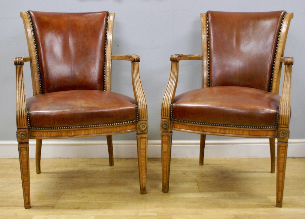 A pair of walnut arm chairs