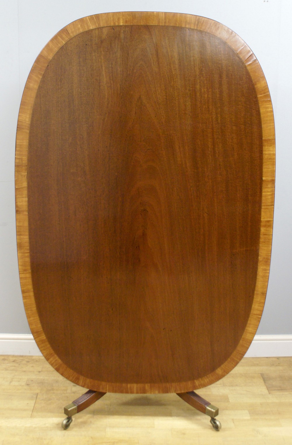 An elliptical George III mahogany breakfast table
