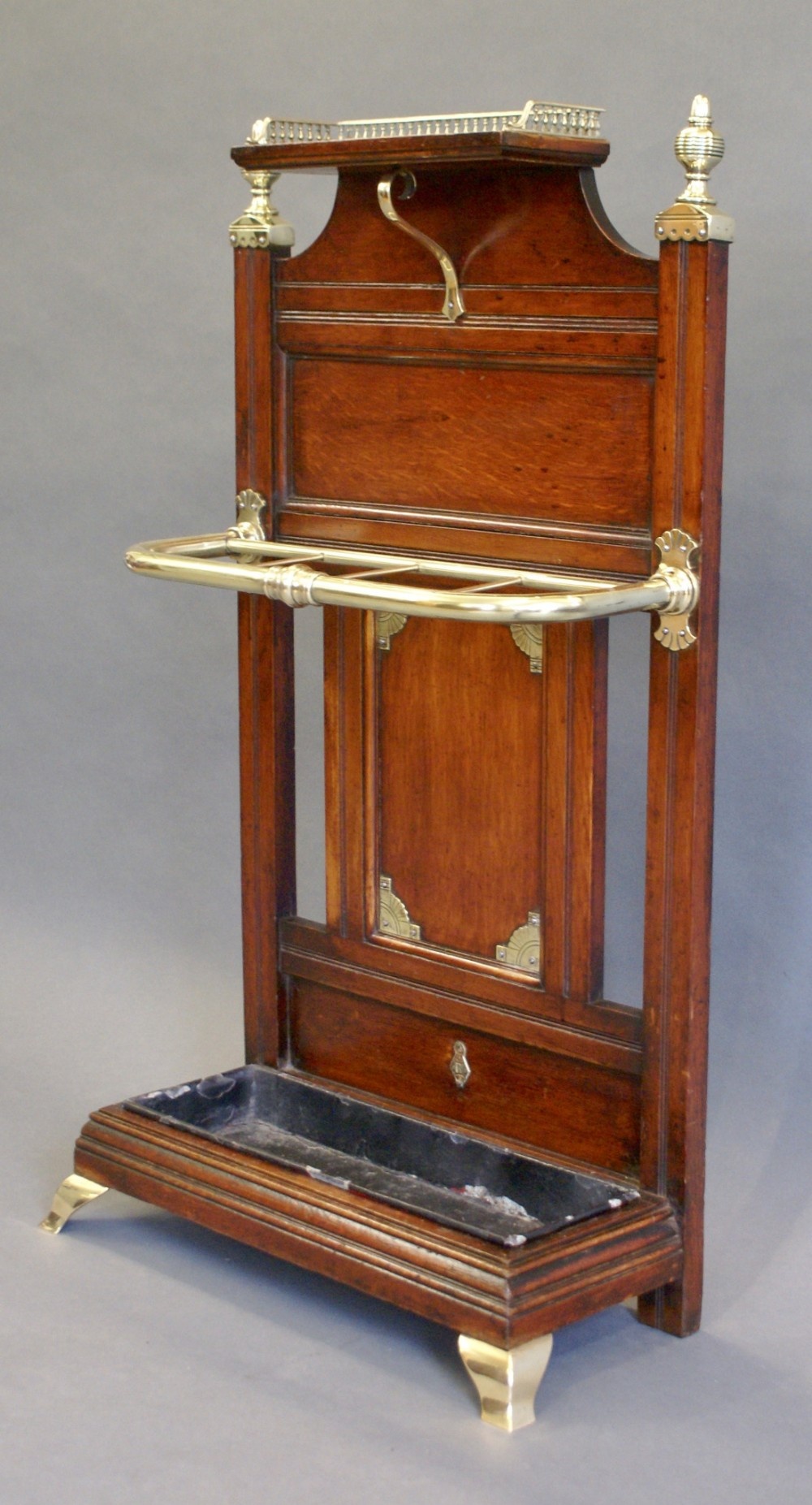 An oak & brass stick stand by James Shoolbred.