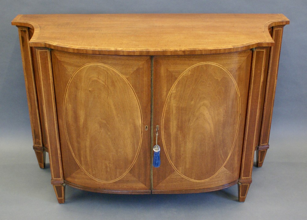 A fine Hepplewhite period serpentine commode