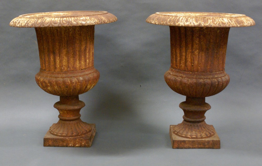 A pair of cast iron garden urns