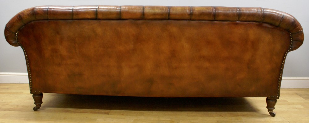 A Victorian buttoned leather chesterfield View V