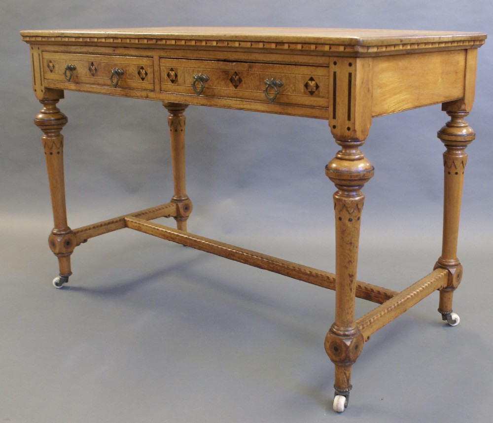 An Arts & Crafts inlaid writing table in the manner of Shoolbred. View II