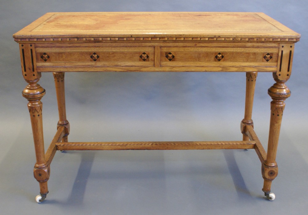 An Arts & Crafts inlaid writing table in the manner of Shoolbred. View IV