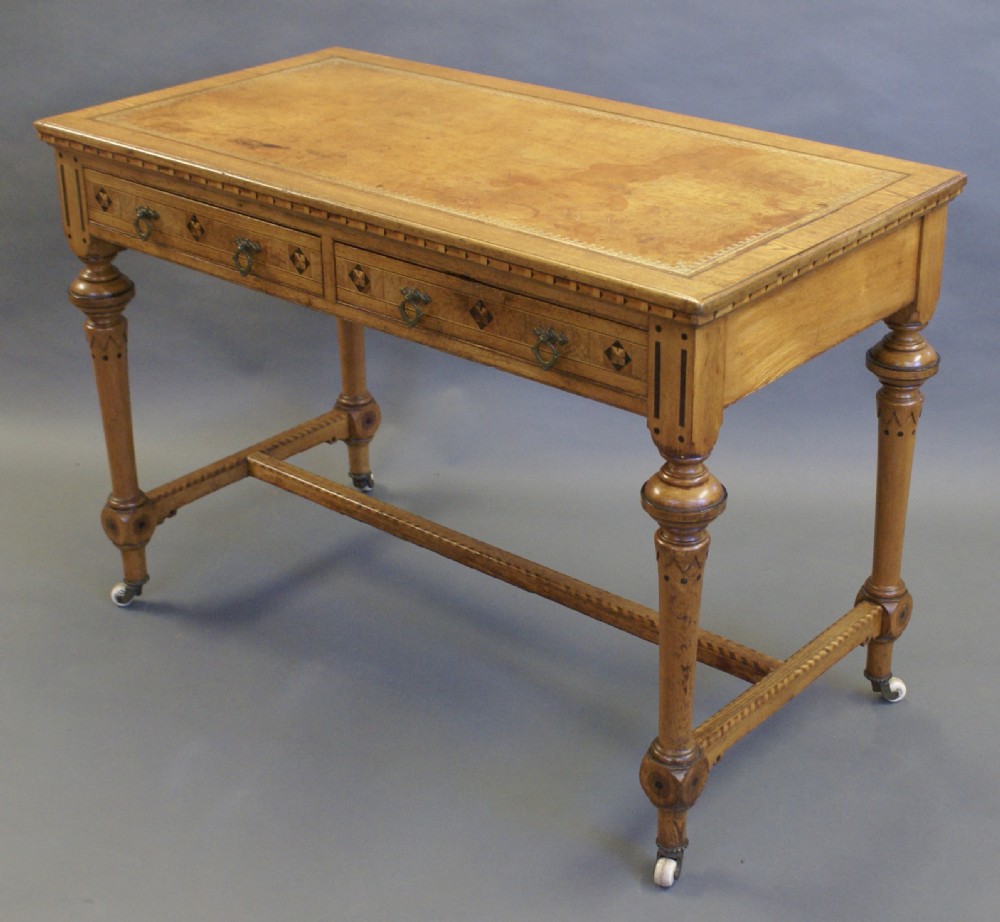 An Arts & Crafts inlaid writing table in the manner of Shoolbred. View VI