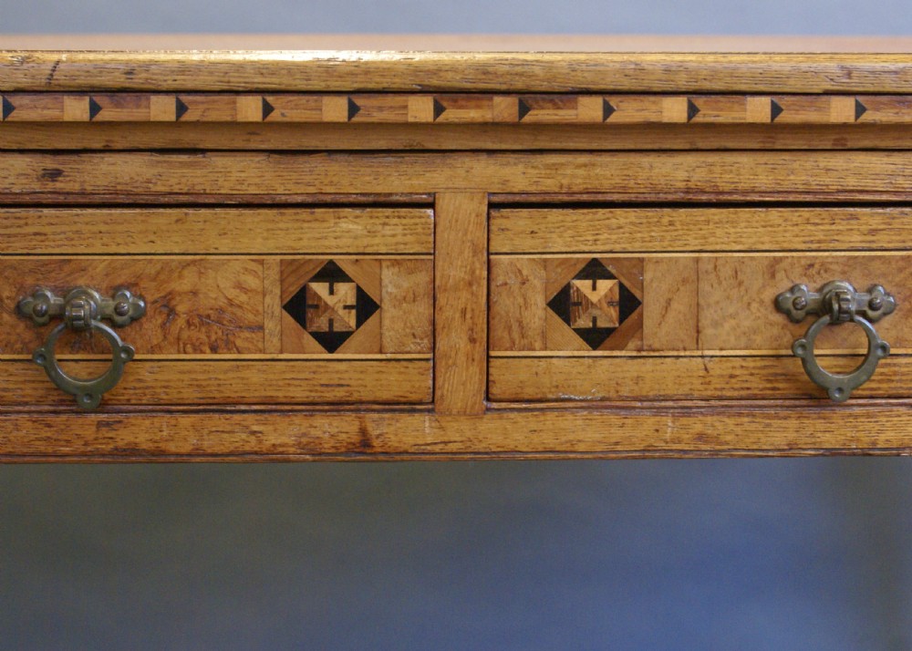 An Arts & Crafts inlaid writing table in the manner of Shoolbred. View VII