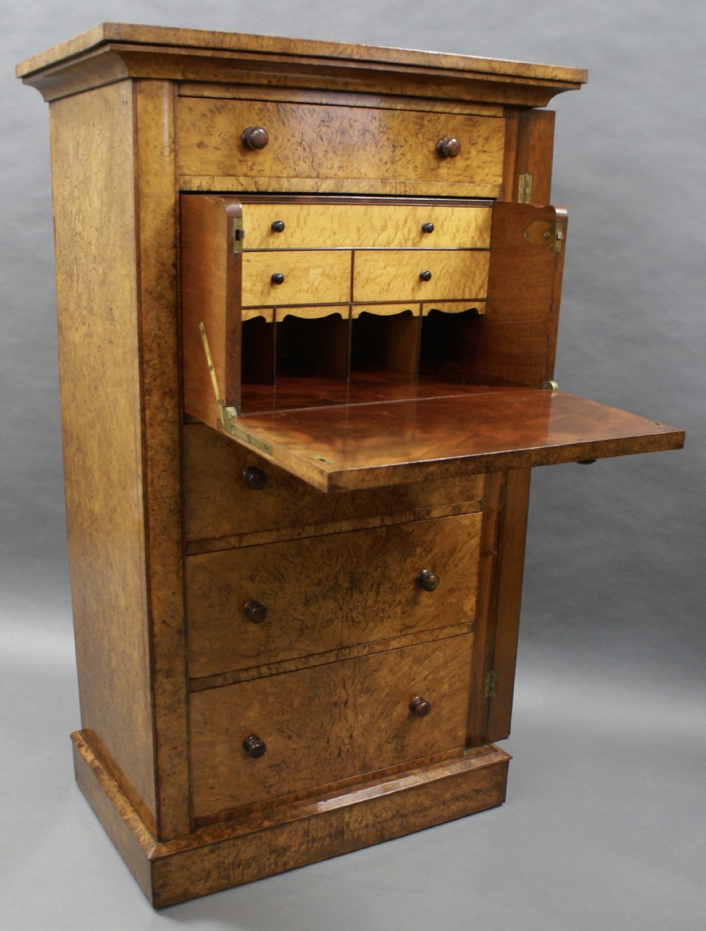 A highly unusual pollard oak secretaire wellington chest