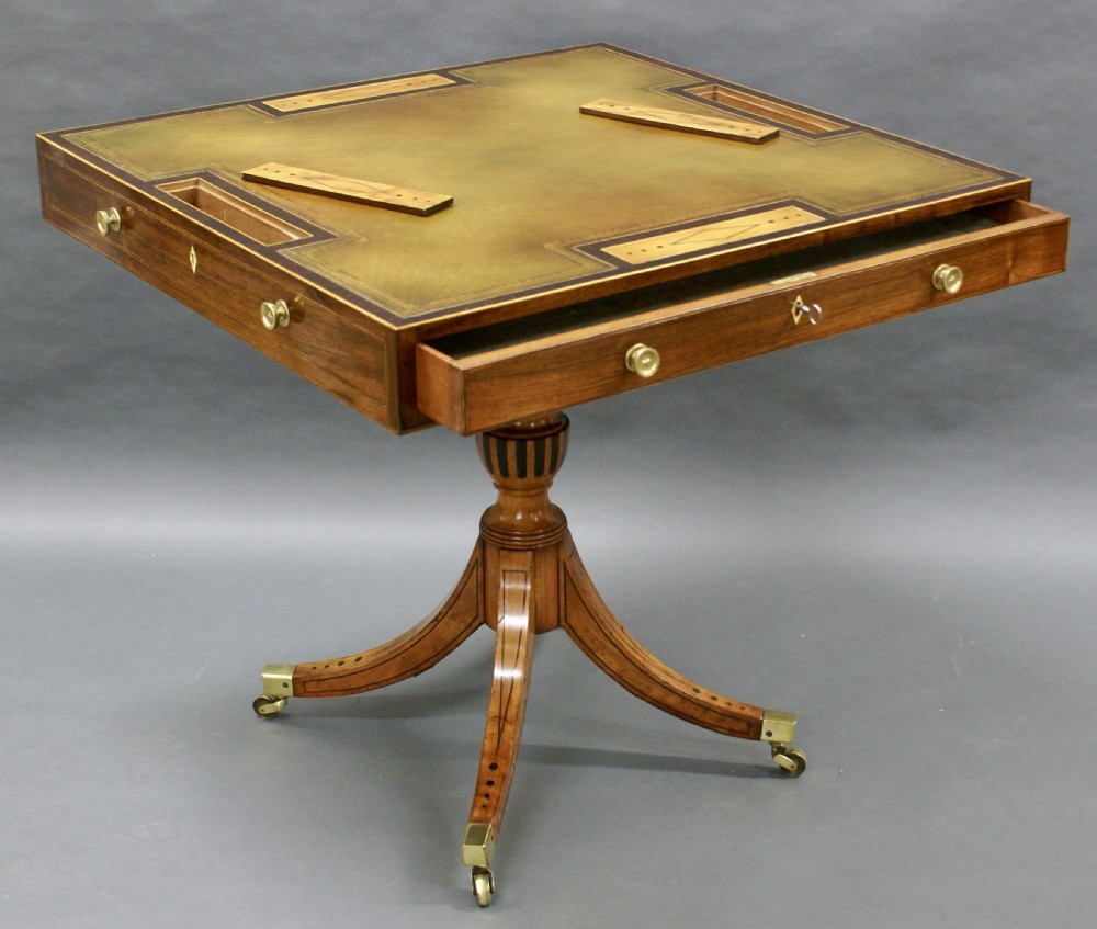 A George III rosewood and satinwood games table View IV