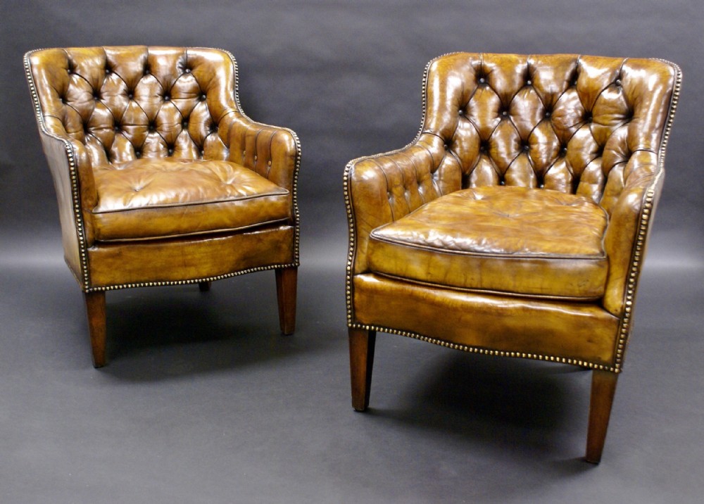 Pair of buttoned leather arm chairs