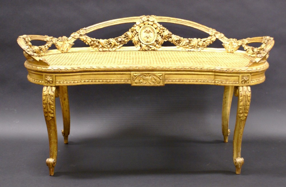An Italian carved wood, gilt window seat View III