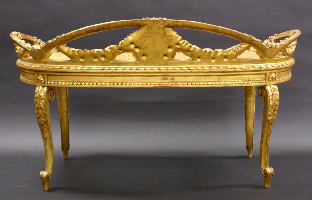 An Italian carved wood, gilt window seat View VI
