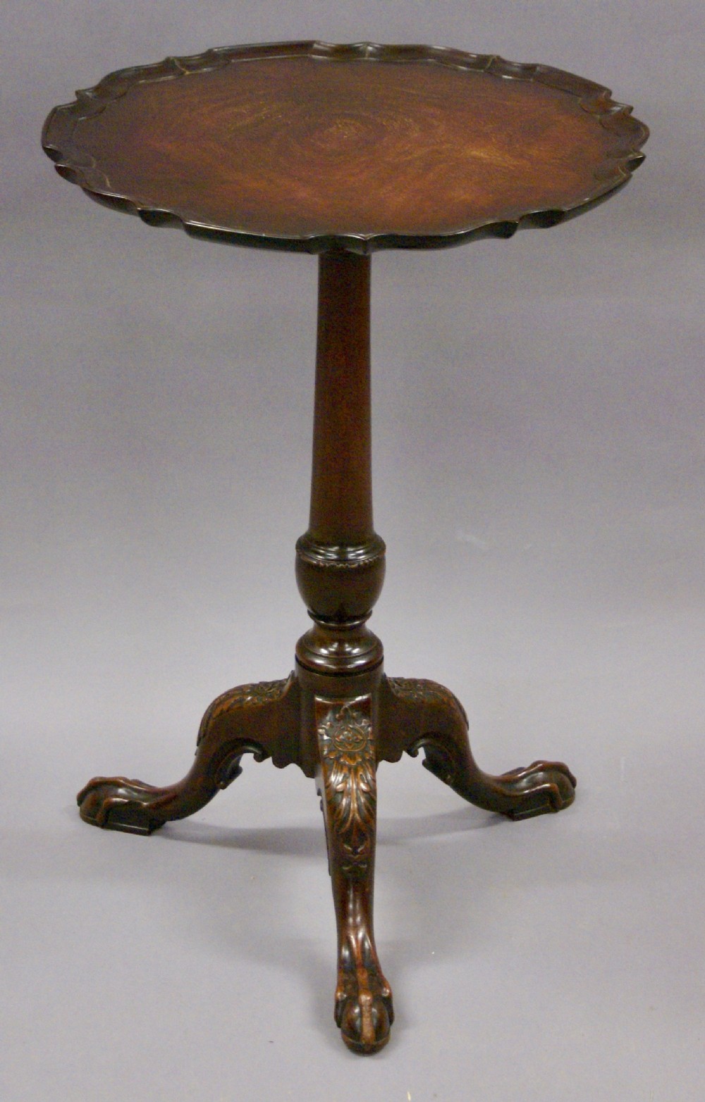 A 19th century carved, piecrust tripod table or kettle stand