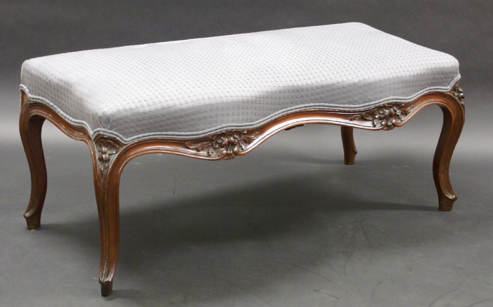 An unusual mahogany carved window seat
