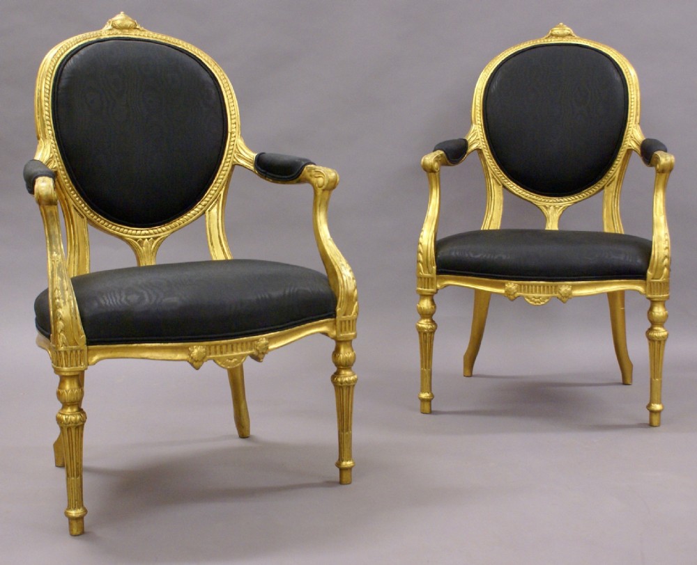 A pair of 18th century English gilt arm chairs