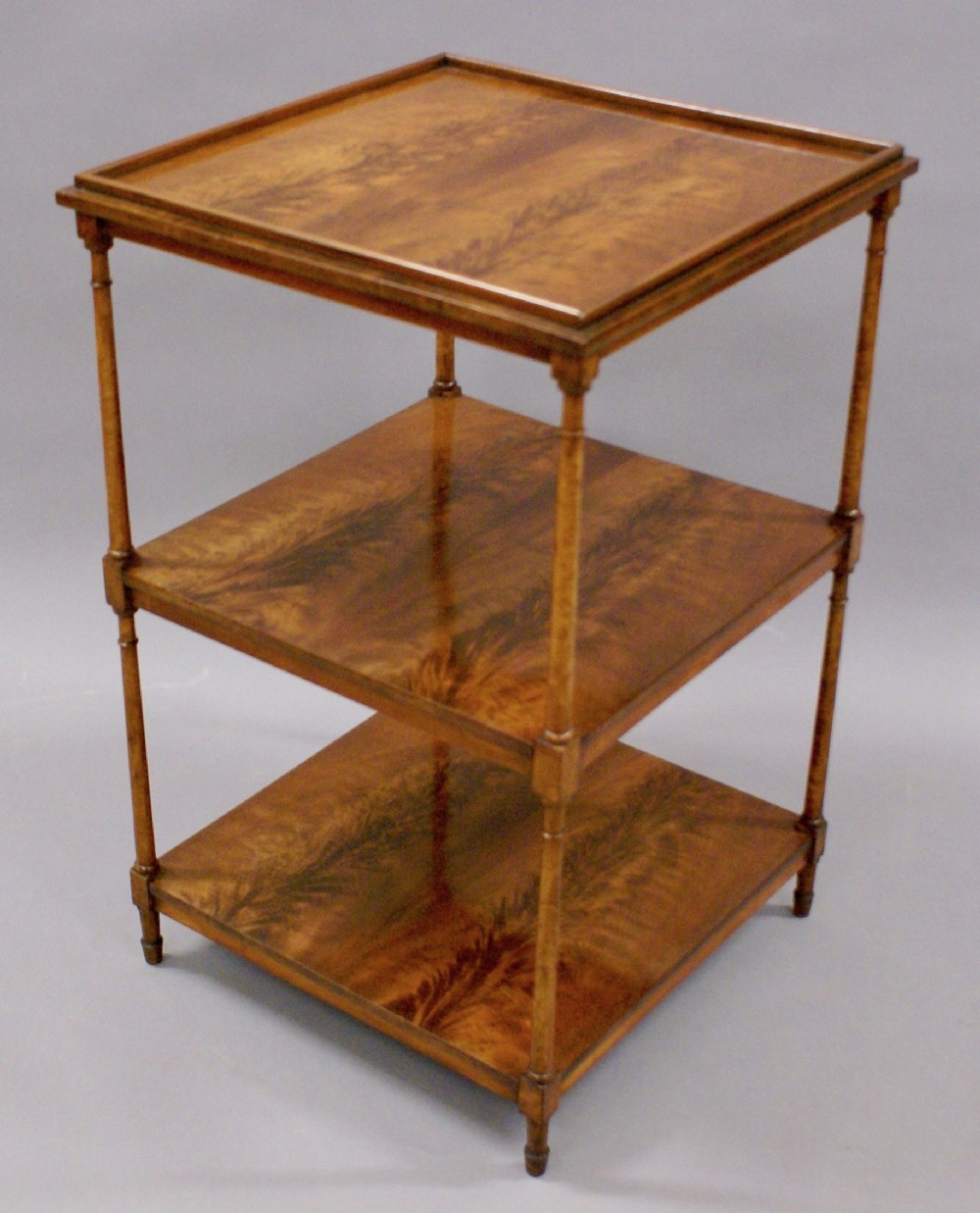 A flame mahogany and birds-eye maple etagere