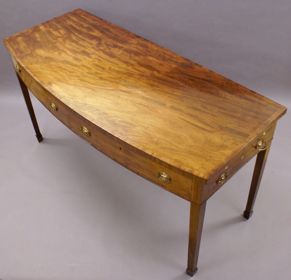 An unusual George III bow-fronted serving table