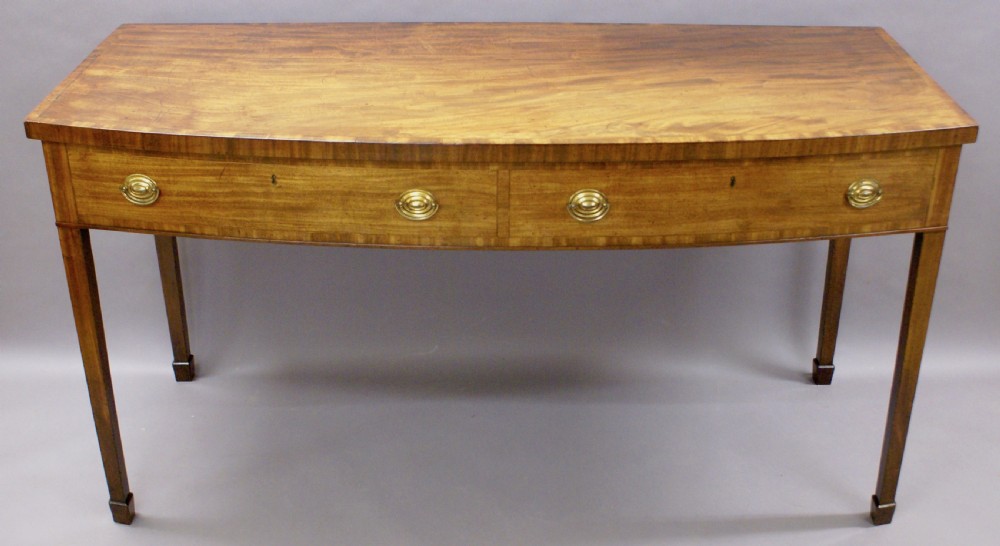 An unusual George III bow-fronted serving table View III