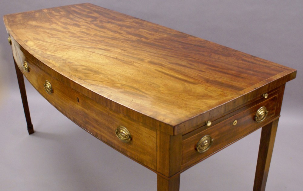 An unusual George III bow-fronted serving table View VIII