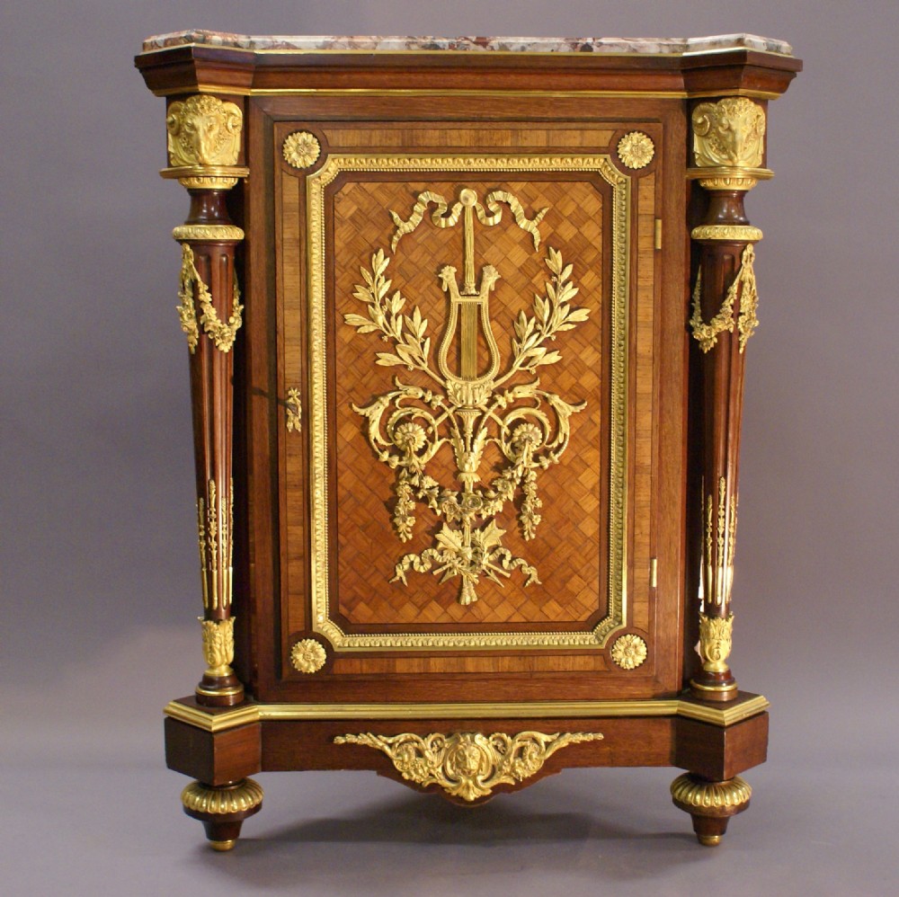 An exceptional ormolu mounted corner cupboard